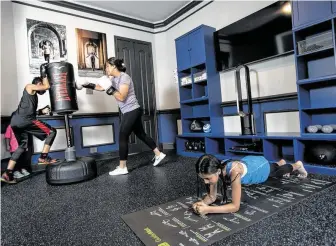  ?? Brett Coomer / Staff photograph­er ?? Don’t let extra rooms go unused. Neda and Shashi Malkani turned the formal dining room they didn’t use into an at-home gym.