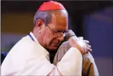  ?? AP PHOTO/ANDREW MEDICHINI ?? Cardinal Patrick D'Rozario, Archbishop of Dhaka, hugs a Rohingya Muslims refugee from Myanmar during an interfaith and ecumenical meeting for peace with Pope Francis, in the garden of the archbishop's residence, in Dhaka, Bangladesh, Friday.