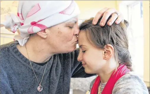  ?? MILLICENT MCKAY/JOURNAL PIONEER ?? Misty-Lynn Caseley gives her daughter, Charisma, a peck on the forehead. Caseley was diagnosed with breast cancer earlier this year. Recently a benefit held in Caseley’s name has provided financial security for the Christmas season.