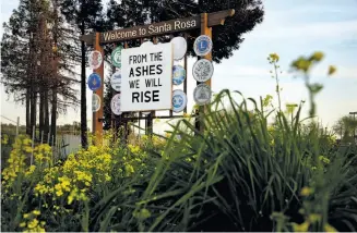  ?? Santiago Mejia / The Chronicle ?? A new sign greets motorists driving down into Santa Rosa on Highway 101. After the Wine Country fires, the sign, “From the ashes we will rise,” was placed in front of the original.