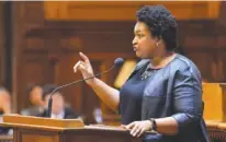  ?? THE ASSOCIATED PRESS ?? House minority leader Stacey Abrams, D-Atlanta, encourages members of her party to support House Bill 338, which passed 138-37 on Wednesday. The legislatio­n seeks to turn around lowperform­ing schools in Georgia.