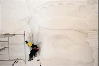  ??  ?? Jessie Armand, of Lachute, works at full speed on a room with a 3D doomsday theme.  In it, the Statue of Liberty is down and the world is coming to an end. Armand is a YouTube sensation who has taken home the gold prize at the ice-carving competitio­n...