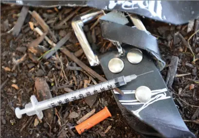 ?? The Daily Courier ?? A used syringe along with a belt used by a drug user lie outside a business along Doyle Avenue in this file photo. On Wednesday, B.C. moved to decriminal­ize possession of small amounts of drugs.