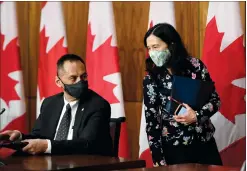  ?? CP PHOTO JUSTIN TANG ?? Chief Public Health Officer of Canada Dr. Theresa Tam speaks with Deputy Chief Public Health Officer Dr. Howard Njoo as they leave a news conference on the COVID-19 pandemic in Ottawa on Tuesday.