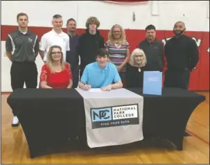  ?? Submitted photo ?? NEW NIGHTHAWK: Tyler Zander, seated center, was joined by his mother Tammy Bailey, left, grandmothe­r Willie Barnes, right, and other supporters when he signed his letter of intent at Mountain Pine High School on April 27 to play college basketball for...