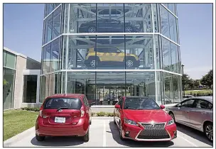  ??  ?? Bloomberg/LAURA BUCKMAN Vehicles sit parked outside the Carvana Co. car vending machine in Frisco, Texas, in the summer of 2017.