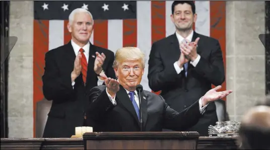  ?? Win McNamee The Associated Press ?? President Donald Trump gestures as delivers his first State of the Union address in the House chamber of the U.S. Capitol to a joint session of Congress on Tuesday in Washington, as Vice President Mike Pence and House Speaker Paul Ryan applaud.