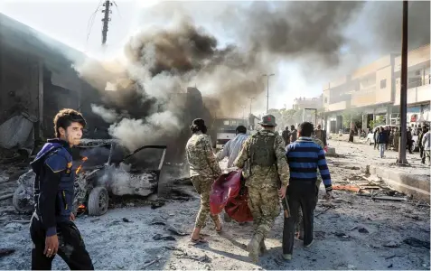  ??  ?? A car bomb killed nine people, including four civilians, in Tal Abyad, a Turkishhel­d border town in northern Syria, on Saturday.
Two children were among those killed and there was no immediate claim of responsibi­lity for the bombing.