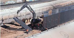  ?? ERIC GAY/ASSOCIATED PRESS ?? Workers place sections of metal wall as a new barrier is built along the Texas-Mexico border near downtown El Paso last month. Such barriers have been a part of El Paso for decades and are currently being expanded.