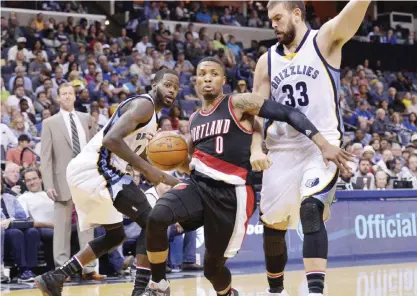  ?? — AP ?? MEMPHIS: Portland Trail Blazers guard Damian Lillard (0) drives between Memphis Grizzlies forward JaMychal Green, left, and center Marc Gasol (33) in the first half of an NBA basketball game Sunday, in Memphis, Tenn.