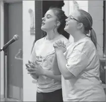  ?? Photo submitted by Palliser Regional Schools ?? Students Kennedi O’Brien, left, and Abbey Dorchak delivered their poem with passion to win the group category at Noble Central School’s Poetry Slam.