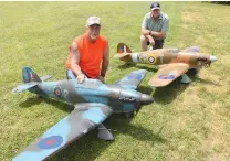  ??  ?? Over the weekend, two impressive Vailly Aviation Hawker Hurricanes could be seen flying in formation. Here, with their Battle of Britain war machines are Robert Vandermule­n of Montgomery, New York, and Kevin Breen of Rock Hill, New York.