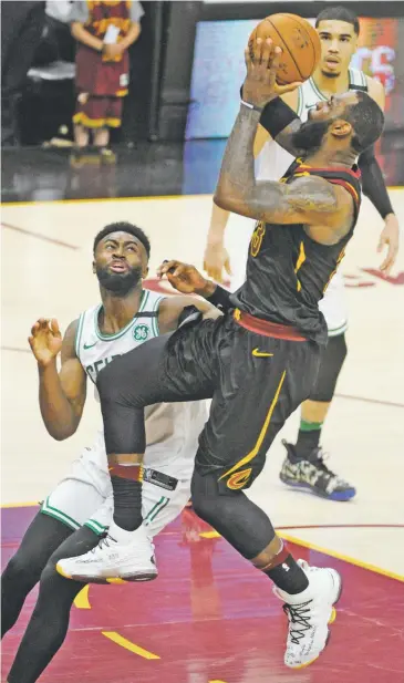  ?? PHIL LONG/ASSOCIATED PRESS ?? The Cavaliers’ LeBron James shoots over the Celtics’ Jaylen Brown on Friday in the Eastern Conference Finals in Cleveland. The Cavs head to Boston for the last game in the series, one that has favored the home team in each contest.