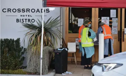  ?? Photograph: Peter Parks/AFP/Getty Images ?? Health workers at a coronaviru­s testing station at the Crossroads Hotel in Sydney. The Australian Border Force has confirmed that staff from Villawood immigratio­n detention centre are self-isolating after attending a party at the hotel.