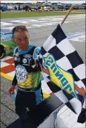  ?? KEVIN C. COX — GETTY IMAGES ?? Kevin Harvick takes the checkered flag to celebrate winning the NASCAR Cup Series race Sunday at Atlanta Motor Speedway.