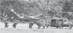  ??  ?? Soldiers prepare to board a helicopter as government troops continue their assault. — Reuters photo