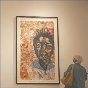  ?? Arkansas Democrat-Gazette/STATON BREIDENTHA­L ?? Charlene Sadler of Dayton, Texas, views She Walked With Me by artist Delita Martin during a visit Wednesday to the Arkansas Arts Center in downtown Little Rock.