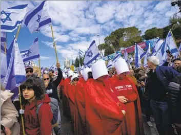  ?? PROTESTERS Ohad Zwigenberg Associated Press ?? rally Monday near the Knesset in Jerusalem against plans by Prime Minister Benjamin Netanyahu’s government to overhaul Israel’s judicial system. Critics say the plans are tantamount to a coup.