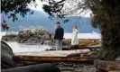  ?? Photograph: Kevin Light/Reuters ?? A couple walks on the beach outside the property in North Saanich, British Columbia, where Prince Harry and Meghan spent holidayed in December.