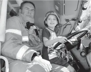  ??  ?? Thomas Hyland rushed to be first to join Drouin West CFA lieutenant Kevin Armstrong behind the steering wheel when the brigade’s fire truck arrived at the Drouin Childcare centre as part fire safety learning last week.