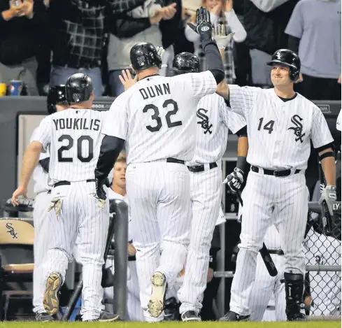  ?? ROB GRABOWSKI, US PRESSWIRE ?? The White Sox’s Adam Dunn is greeted by teammates after hitting one of his two home runs Monday vs. the Indians. He has 41 for the season.