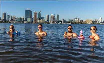  ?? Photograph: Paul Kane/Getty Images ?? Locals cool off with a drink in Perth’s Swan River on Saturday as the city baked in 41.1C heat – the fifth day in a row over 40C before a sixth was registered on Sunday. A cool change is expected on Monday.