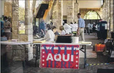  ?? Sergio Flores Getty I mages ?? EARLY VOTERS keep poll workers busy in Austin, Texas, on Oct. 13, the f irst day for in- person voting in the state. More than 8 million people have already cast ballots in Texas, many after waiting in line for hours.