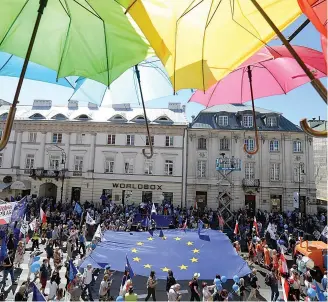  ?? AP Photo/Czarek Sokolowski ?? ■ People hold a European flag as they take part in a demonstrat­ion during an anti-government protest, called “Freedom March,” and are organized by opposition parties Saturday in Warsaw, Poland.