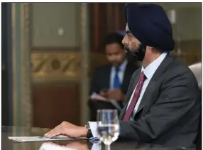  ?? (AP) ?? Ajay Banga, former chairman of Mastercard, listens during a meeting with Vice President Kamala Harris and business leaders about economic developmen­t in 2021.