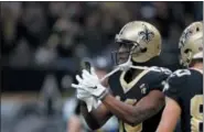  ?? BILL FEIG — THE ASSOCIATED PRESS ?? New Orleans Saints wide receiver Michael Thomas (13) pulls out a cell phone after his 72 yard touchdown reception in the second half of an NFL football game against the Los Angeles Rams in New Orleans, Sunday.