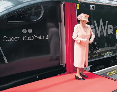  ??  ?? The Queen unveils a new breed of hybrid train at Paddington Station, London, after boarding it for a journey that followed the route of Queen Victoria’s first train ride 175 years ago