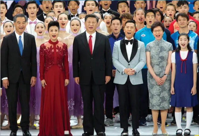  ?? Photos: AFP ?? President Xi Jinping (center) sings the song, “Singing for the Motherland” with officials and performers at a grand gala Friday night to celebrate the 20th anniversar­y of Hong Kong’s return to China. The gala, which was held at the Hong Kong Convention...