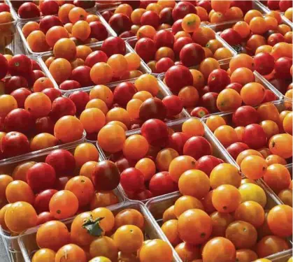  ?? J. Scott Applewhite / Associated Press file ?? Tomatoes are for sale at a farmers market in Falls Church, Va. Buying fresh fruit and vegetables at farmers markets offers opportunit­ies to save money in ways sometimes not find at a store.