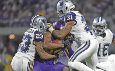  ?? HANNAH FOSLIEN / GETTY IMAGES / AFP ?? Cordarrell­e Patterson of the Minnesota Vikings is tackled by Leon McFadden (23) and Byron Jones of the Dallas Cowboys in the fourth quarter of Thursday’s NFL clash at US Bank Stadium in Minneapoli­s, Minnesota.