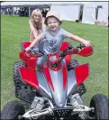  ??  ?? Charlie Brailsford on a quad bike pushed by his mother