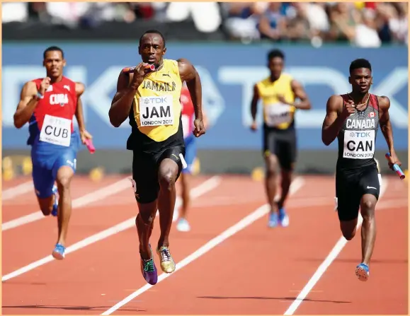  ??  ?? Usain Bolt takes the baton on the final leg of Jamaica’s 4x100-metre relay as his team blazes to victory in their heat at 37.95 seconds yesterday