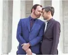  ??  ?? Charlie Craig, left, and David Mullins on Tuesday leave the Supreme Court, which heard arguments in their case against a baker who refused to make their wedding cake.