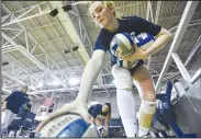  ?? ?? Hannah Watkins of the University of Arkansas at Fort Smith collects volleyball­s Wednesday at the UAFS Stubblefie­ld Center. (River Valley Democrat-Gazette/Hank Layton)