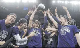  ?? Isaac Brekken The Associated Press ?? Utah State guard Sam Merrill holds aloft the Mountain West tournament MVP trophy after leading the Aggies to the title.