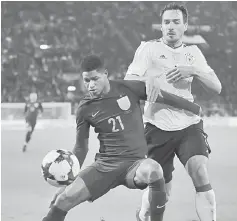  ??  ?? England’s Marcus Rashford (left) in action with Germany’s Mats Hummels during an Internatio­nal friendly match at Signal-Iduna-Park in Dortmund, Germany in this file photo. — Reuters photo