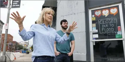  ?? PHOTO/CHARLIE NEIBERGALL ?? Kelli Grubbs and her son Justin stand in front of flood closed micro brewery adjacent to their business, on July 16, in Davenport, Iowa. AP
