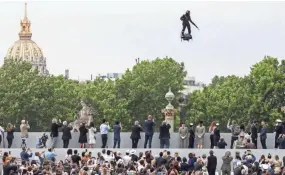  ?? GETTY IMAGES ?? Zapata CEO Franky Zapata flies a jet-powered hoverboard or “Flyboard” prior to the Bastille Day military parade down the Champs-Elysees avenue in Paris on Sunday.