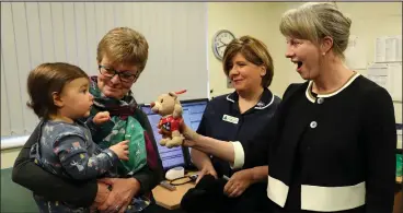  ??  ?? Health Secretary Shona Robison chats to Jane McNiven with her granddaugh­ter Evie and nurse Eileen McGinness during a visit to The Green medical practice in Clydebank for the launch of the proposed GP contract