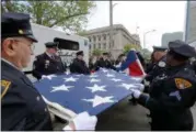  ?? JONATHAN TRESSLER — THE NEWS-HERALD ?? The big-flag-carrying contingent of the 32nd annual Greater Cleveland Peace Officers Memorial Parade and Memorial Service in downtown Cleveland fold Old Glory properly following the parade May 19.