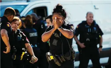  ?? Marie D. De Jesús / Staff photograph­er ?? A Harris County Precinct 4 deputy mourns fellow Deputy Kareem Atkins, who was shot to death early Saturday in north Houston. He is the first Precinct 4 deputy fatally shot in the agency’s history.