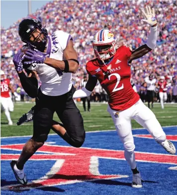  ?? AP ?? TCU wide receiver Quentin Johnston hauls in the go-ahead touchdown in front of KU defender Cobee Bryant.
