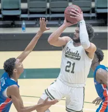  ?? Bethany Baker, The Coloradoan ?? Colorado State guard David Roddy, right, shoots against Boise State in the first half at Moby Arena on Wednesday night.