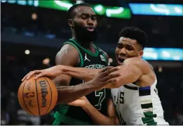  ?? MORRY GASH — THE ASSOCIATED PRESS ?? Milwaukee Bucks' Giannis Antetokoun­mpo and Boston Celtics' Jaylen Brown battle during the first half of Game 4of an Eastern Conference semifinals game Monday.