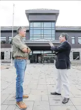  ?? JOHN MAHONEY ?? St-Lazare Mayor Robert Grimaudo, right, talks with the town’s director general Serge Tremblay outside the new town hall on Friday.