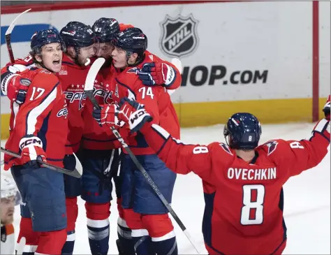  ?? MANUEL BALCE CENETA — THE ASSOCIATED PRESS ?? Alex Ovechkin (8), celebrates a goal by Anthony Mantha (39) with other friends in the third period Friday in Washington,